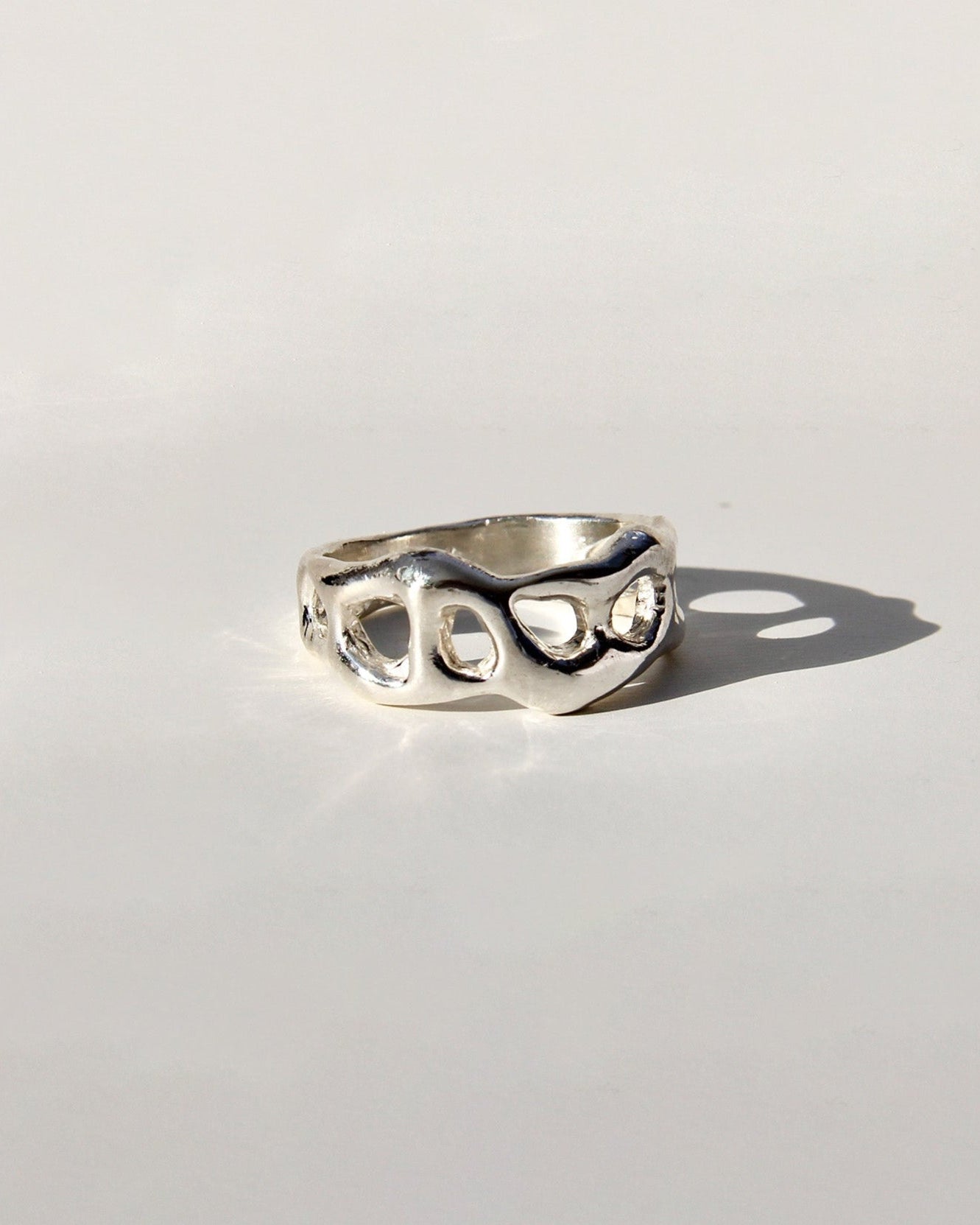 Silver ring on a light gray background